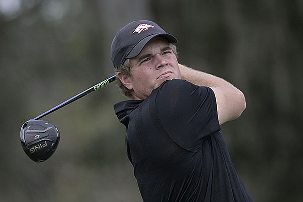 Mason Overstreet, of Arkansas, watches his tee shot on the 16th hole during an NCAA golf tournament on Friday, Feb. 12, 2021, in Gainesville, Fla. (AP Photo/Phelan M. Ebenhack)