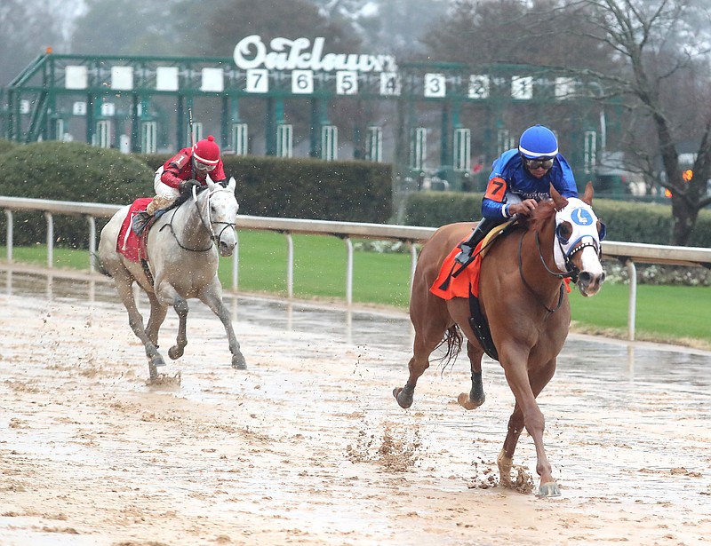 Jockey Luis Saez pilots Mystic Guide (7), right, across the wire in front of Sliver Prospector (1) and jockey Ricardo Santana Jr. to win the Razorback Handicap at Oaklawn Park Saturday, Feb. 27. - Photo by Richard Rasmussen of The Sentinel-Record