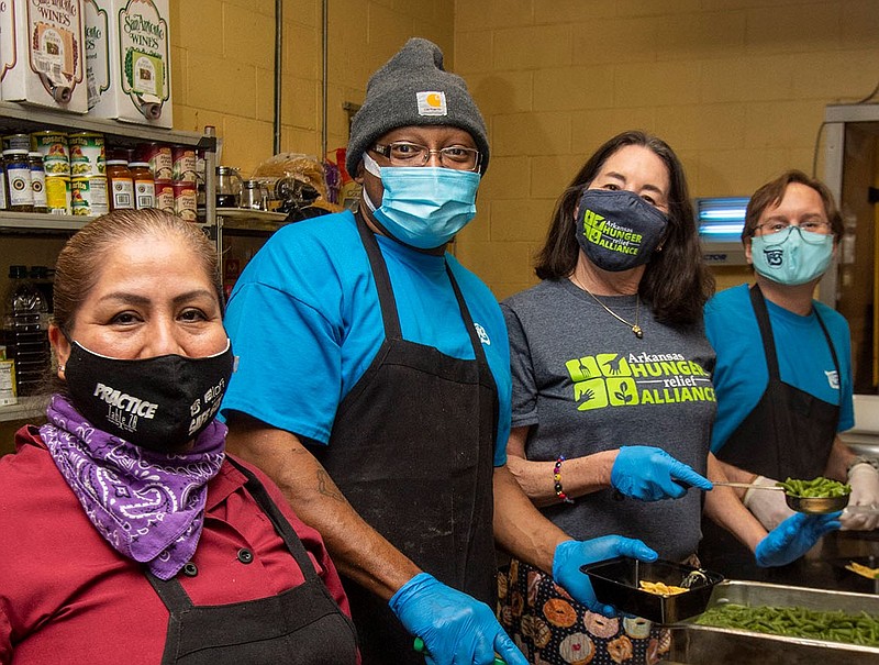 Agueda Romero, Apollos Merriweather, Capi Peck and Tony Peck on 02/22/2021 at Trio‚Äôs Restaurant prepare boxes of green beans and chicken pasta for the Plating Change Program