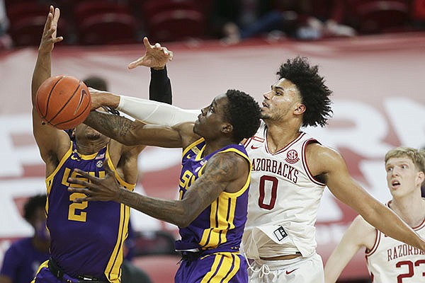 Arkansas' Justin Smith (0) attempts to block a shot during a game against LSU on Saturday, Feb. 27, 2021, in Fayetteville.