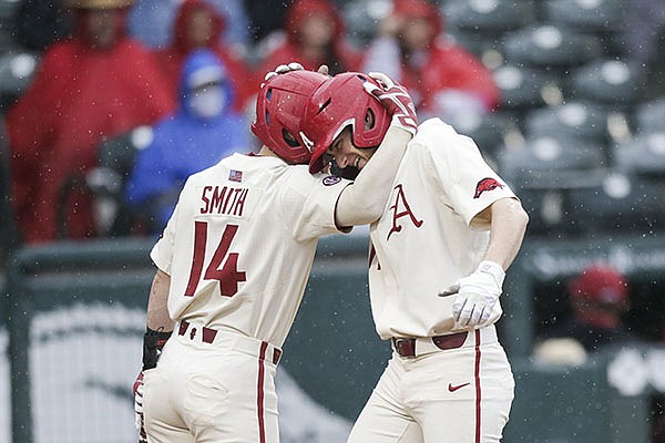 Arkansas' Cullen Smith (14) and Brady Slavens embrace after Slavens hit a home run during a game against Southeast Missouri State on Sunday, Feb. 28, 2021, in Fayetteville. Arkansas' Cullen Smith (14) and Brady Slavens embrace after Slavens hit a home run during a game against Southeast Missouri State on Sunday, Feb. 28, 2021, in Fayetteville.