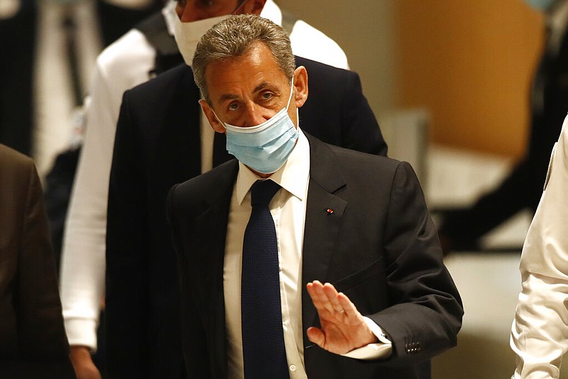 Former French President Nicolas Sarkozy arrives at the courtroom Monday, March 1, 2021 in Paris. The verdict is expected in a landmark corruption and influence-peddling trial that has put French former President Nicolas Sarkozy at risk of a prison sentence if he is convicted. Sarkozy, who was president from 2007 to 2012, firmly denied all the allegations against him during the 10-day trial that took place at the end of last year. (AP Photo/Michel Euler)