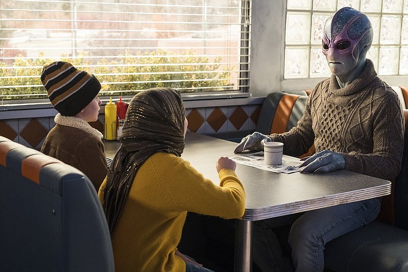 Judah Prehn (from left) Gracelyn Awad Rinke and Alien Harry (Alan Tudyk) star in the new Syfy series “Resident Alien.” (James Dittinger/Syfy via AP)