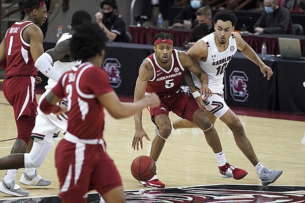 Arkansas guard Moses Moody (5) dribbles next to South Carolina forward Justin Minaya (10) during the second half of an NCAA college basketball game Tuesday, March 2, 2021, in Columbia, S.C. (AP Photo/Sean Rayford) Arkansas guard Moses Moody (5) dribbles next to South Carolina forward Justin Minaya (10) during the second half of an NCAA college basketball game Tuesday, March 2, 2021, in Columbia, S.C. (AP Photo/Sean Rayford)