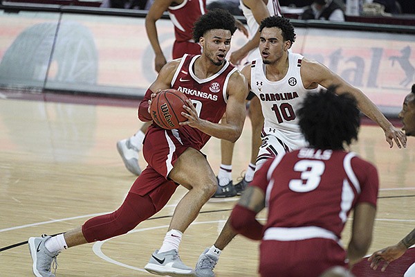 Arkansas forward Justin Smith (0) drives against South Carolina forward Justin Minaya (10) during the second half of an NCAA college basketball game Tuesday, March 2, 2021, in Columbia, S.C. (AP Photo/Sean Rayford) Arkansas forward Justin Smith (0) drives against South Carolina forward Justin Minaya (10) during the second half of an NCAA college basketball game Tuesday, March 2, 2021, in Columbia, S.C. (AP Photo/Sean Rayford)