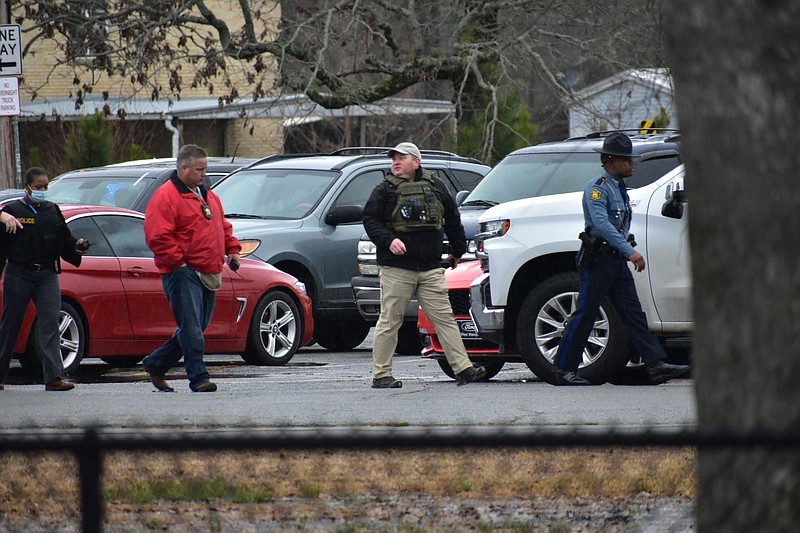 Law enforcement personnel pace the campus of Watson Chapel Junior High School on Monday, March 1, 2021, responding to a call of a shooting. (Pine Bluff Commercial/I.C. Murrell)