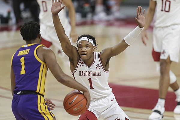 Arkansas guard JD Notae (facing) defends LSU guard Javonte Smart during a game Saturday, Feb. 27, 2021, in Fayetteville.