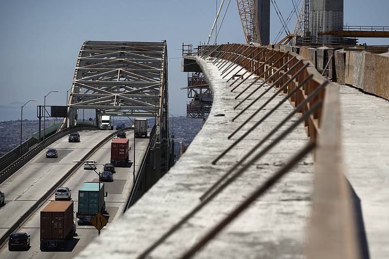 Traffic crosses the old Gerald Desmond Bridge next to its replacement bridge under construction in Long Beach, Calif., in 2018. The American Society of Civil Engineers gave America’s infrastructure — roads, public transit and storm water systems — an overall grade of C- in a recent report.
(AP)