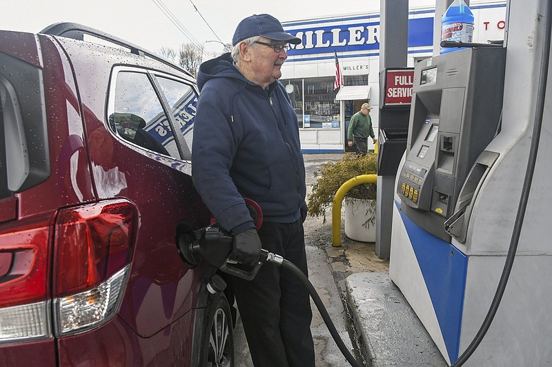 Francis Miller, owner and operater of Miller's Gas and Service, pumps gas for a customer at his station on N. Lehigh Avenue in Frackville, Pa., on Monday, March 1 2021. The station still provides full-service, following in the footsteps of his late father, Francis Miller, who founded the business in 1945. The price per gallon has risen about every other week, and it's selling for about $2.99 or a few pennies less at many places in Schuylkill County. (Jacqueline Dormer/Republican-Herald via AP)