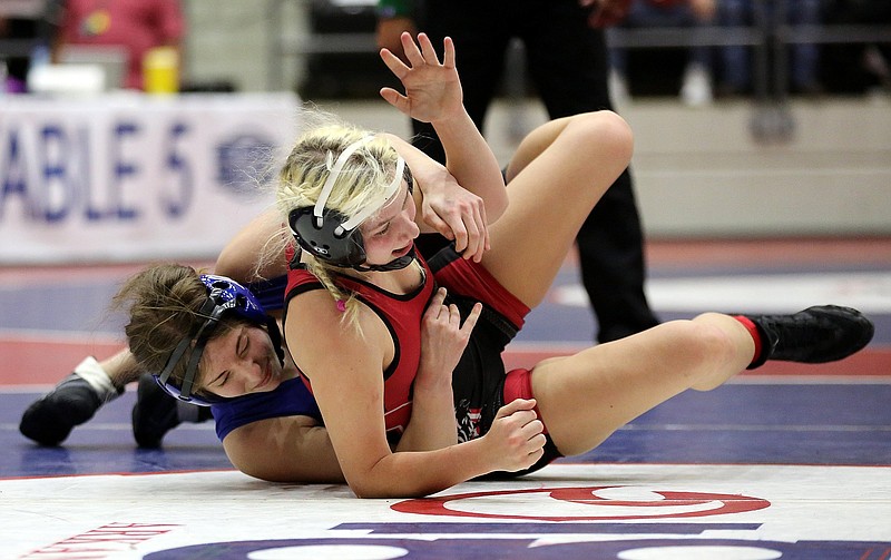 Mountain Home's Kylee Sabella (left) slams Searcy's Mykenzie Clark to the mat in the 132 weight class championship match during the Arkansas Girls Wrestling State Tournament on Wednesday, March 3, 2021, at the Jack Stephens Center in Little Rock. Sabella won the match. .More photos at www.arkansasonline.com/34wrestling/.(Arkansas Democrat-Gazette/Thomas Metthe)