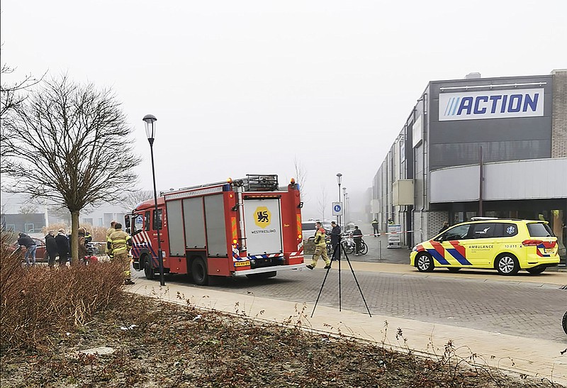 Emergency services attend the scene close to a coronavirus test station after a homemade firework was detonated in Bovenkarspel, Netherlands, Wednesday March 3, 2021.  The homemade firework, a so-called "pipe" firework, was fired near to the Covid test station Wednesday and broke some windows but no people are reported injured. (Stefanie ter Koele / AP)