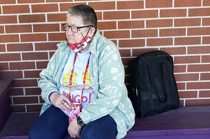 Pat Brown waits outside the Don Bosco Senior Center in Kansas City, Mo., Wednesday, March 3, 2021. Brown knows she needs the vaccine because her asthma and diabetes put her at higher risk of serious covid-19 complications. But Wall hasn’t attempted to schedule an appointment and didn’t even know if they were being offered in her area yet; she says she is too overwhelmed. (AP Photo/Orlin Wagner)