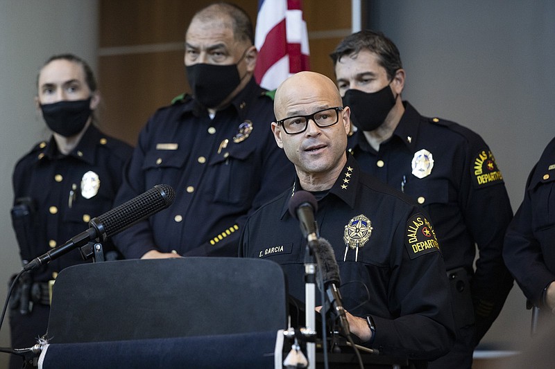 Chief Eddie García, center, speaks with media during a press conference regarding the arrest and capital murder charges against Officer Bryan Riser at the Dallas Police Department headquarters on Thursday, March 4, 2021, in Dallas. Riser was arrested Thursday on two counts of capital murder in two unconnected 2017 killings that weren't related to his police work, authorities said. Riser, a 13-year veteran of the force, was taken into custody Thursday morning and brought to the Dallas County Jail for processing, according to a statement from the police department. (Lynda M. González/The Dallas Morning News via AP)