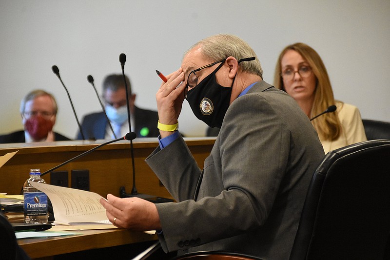 Sen. Kim Hammer, R-Benton, looks through papers during a committee meeting Thursday. During consideration by the full Senate of his bill to have lawmakers weigh in on public health directives, Hammer said “it is important that we as the legislative branch be inserted into the decision.”
(Arkansas Democrat-Gazette/Staci Vandagriff)