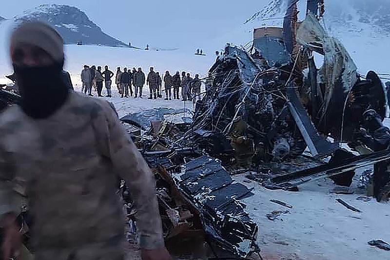 Soldiers and rescue workers stand around the wreckage after an army helicopter crashed in Bitlis, eastern Turkey, Thursday March 4, 2021. Turkey’s Defense Ministry says a military helicopter has crashed, killing several soldiers on board and injuring others. News reports said the victims included an army corps commander. The ministry described the crash as an accident, but it wasn’t immediately known what caused it. (IHA via AP )