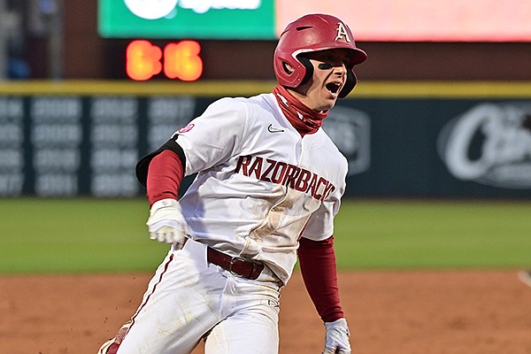 Arkansas second baseman Robert Moore rounds third after he hit a go-ahead home run during the eighth inning of a game against Murray State on Friday, March 5, 2021, in Fayetteville.