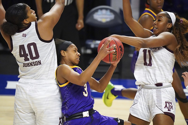 LSU guard Khayla Pointer (3) is defended by Texas A&M guard Kayla Wells (11) and Ciera Johnson (40) during the second half of Friday's game at the Southeastern Conference tournament in Greenville, S.C. Texas A&M won 77-58. - Photo by Sean Rayford of The Associated Press