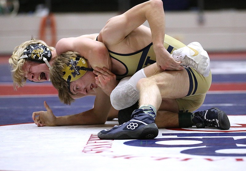 Bentonville's Tristan Stafford pulls down Bentonville West's Tyler Holmes in the Class 6A 120 weight class state championship on Friday, March 5, 2021, during the State Wrestling Tournament at the Jack Stephens Center in Little Rock. Stafford won the match. .More photos at www.arkansasonline.com/36wrestling/.(Arkansas Democrat-Gazette/Thomas Metthe)