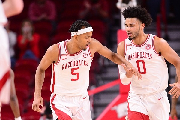 Arkansas guard Moses Moody and forward Justin Smith react to a play during a game against Texas A&M on March 6, 2021, in Bud Walton Arena in Fayetteville.