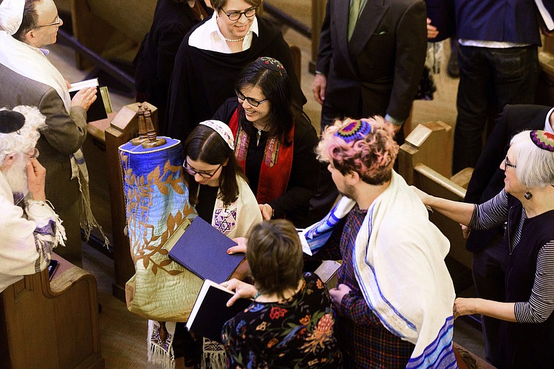 Rabbi Jacqueline Mates-Muchin follows Hanna Raskin as she carries a Torah scroll during her bat mitzvah on Feb. 1, 2020, at Temple Sinai in Oakland, Calif. The coronavirus pandemic has thrown a wrench into the planned-in-advance bar and bat mitzvahs that symbolize a child’s coming of age in Judaism.
(AP/Noah Berger)