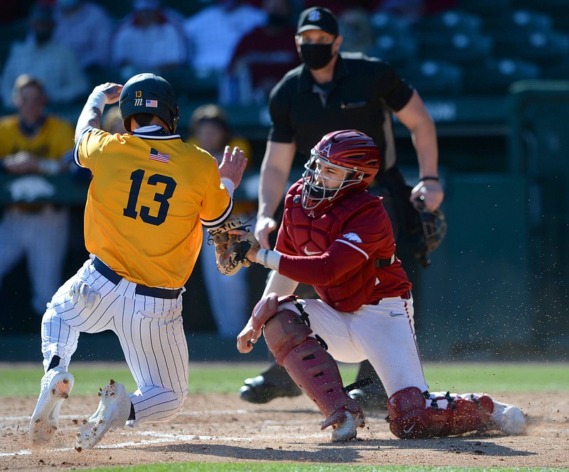 FILE — Senior catcher Casey Opitz tags out Murray State’s Trey Woosley at the plate during the sixth inning of top-ranked Arkansas’ victory at Baum-Walker Stadium in Fayetteville in this March 6, 2021 file photo. More photos available at arkansasonline.com/37msuua.
(NWA Democrat-Gazette/Andy Shupe)