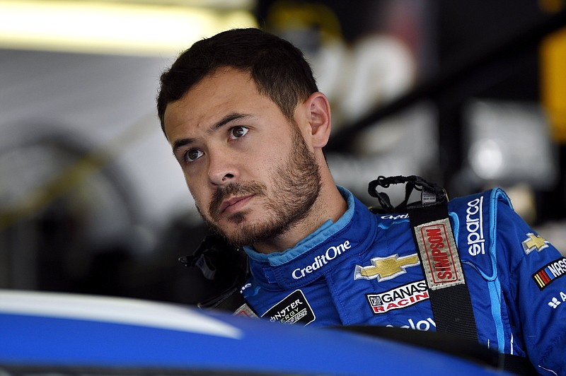 FILE - Kyle Larson climbs into his car for a practice session for a NASCAR Cup Series auto race in Long Pond, Pa., in this Saturday, July 27, 2019, file photo. Larson was banished from NASCAR for all but the first month of his last season, his punishment for using a racial slur while racing online. Rick Hendrick felt the driver paid his penalty and deserved a second chance, one that begins with the season-opening Daytona 500.  (AP Photo/Derik Hamilton)