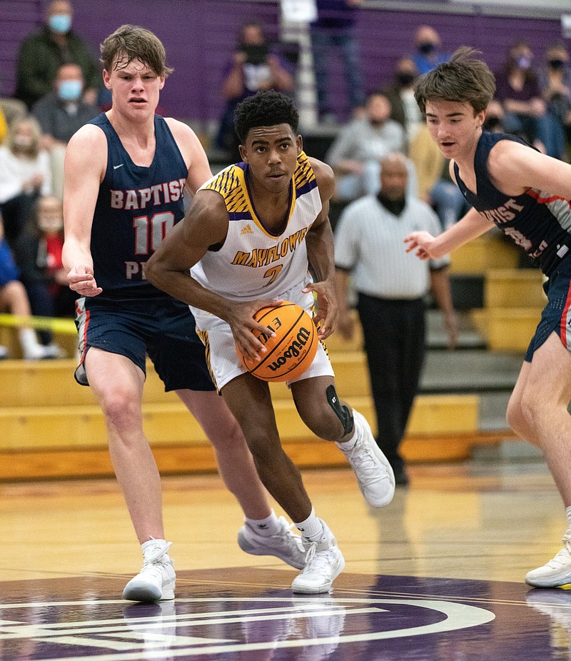 Mayflowers BJ Gilliam (middle) looks to pass the ball to a teammate Saturday night at CAC basketball gymnasium. (Arkansas Democrat-Gazette/Justin Cunningham)