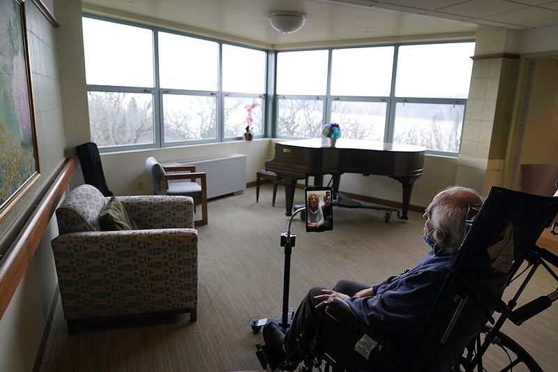 Jerry Woloz, 79, visits with family via a tablet at The Hebrew Home at Riverdale in New York in this Dec. 9, 2020, file photo. During the coronavirus pandemic, video and drive-by visits have been the only types available for most residents of nursing homes. (AP/Seth Wenig)