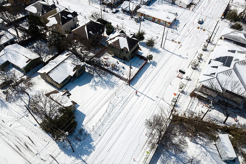 An Austin, Texas, neighborhood is blanketed in snow Feb. 15 in the aftermath of a rare winter storm. The pandemic has already thrown weddings into a tailspin, but a sudden and devastating storm in Texas was one more hurdle to overcome for vendors and couples.
(The New York Times/Tamir Kalifa)