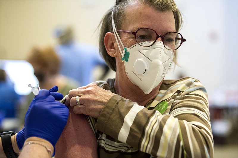 Belinda Smith receives her first dose of the Pfizer vaccine at a UAMS vaccine clinic in University Park in Little Rock on Monday, March 8, 2021. (Arkansas Democrat-Gazette/Stephen Swofford)