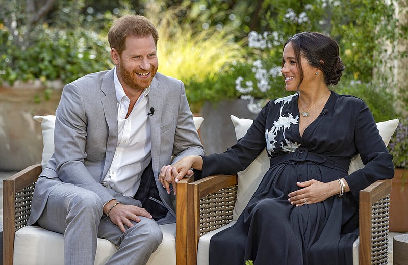 This image provided by Harpo Productions shows Prince Harry, left, and Meghan, Duchess of Sussex, speaking about expecting their second child during an interview with Oprah Winfrey.(Joe Pugliese/Harpo Productions via AP)