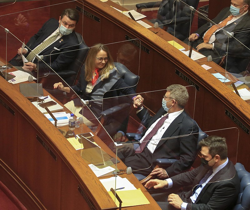 Sen. Ricky Hill, second from right, R-Cabot, congratulates Sen. Missy Irvin, second from left, R-Mountain View, Tuesday March 9, 2021 at the state Capitol in Little Rock after senators including Jason Rapert, left, R-Conway, and Jonathan Dismang, R-Beebe, voted to pass Senate Bill 410 that would change the state’s Medicaid expansion that provides largely private health insurance to low-income Arkansans. More photos at arkansasonline.com/310senate/. (Arkansas Democrat-Gazette/Staton Breidenthal)