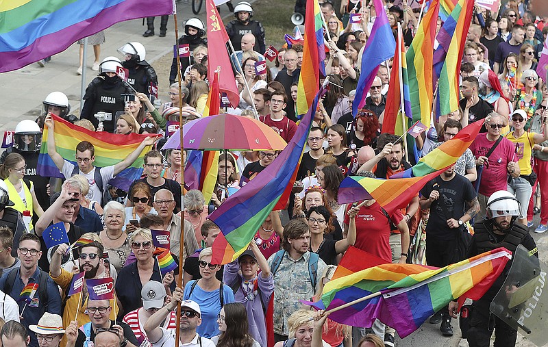 LGBT activists and their supporters gather for the first-ever pride parade in the central city of Plock, Poland, on Saturday, Aug. 10, 2019. The parade comes as the country finds itself bitterly divided over the growing visibility of the LGBT issue and as the government and powerful Catholic church denounce gay rights as a threat to society. (AP Photo/Czarek Sokolowski)