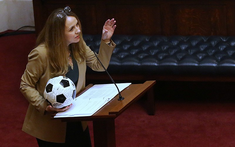 Sen. Missy Irvin holds a soccer ball Wednesday while speaking about Senate Bill 354, which she said was “designed to create fairness in women’s sports.” (Arkansas Democrat-Gazette/Thomas Metthe)