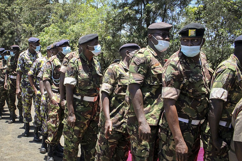 Personnel of the Kenya Defence Forces (KDF) queue up to receive a coronavirus vaccination at the launch of a campaign to vaccinate the country's military and curb the spread of COVID-19, at the Kahawa Garrison near Nairobi, Kenya Thursday, March 11, 2021. As Africa lags in its efforts to vaccinate its 1.3 billion people, the continent must develop the capacity to produce its own COVID-19 vaccines, the director of the Africa Centers for Disease Control and Prevention Dr. John Nkengasong told a press briefing Thursday March 11, 2021.(AP Photo)