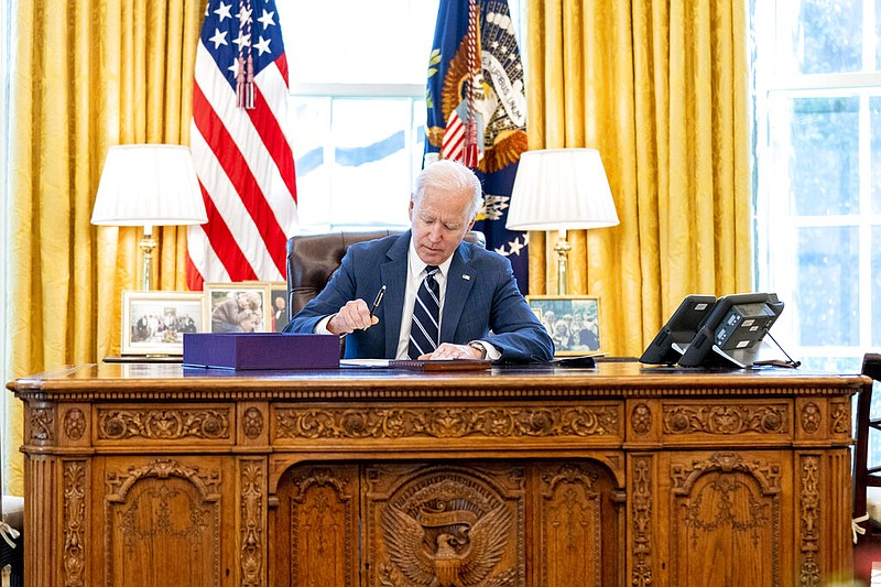President Joe Biden signs the American Rescue Plan, a coronavirus relief package, in the Oval Office of the White House on Thursday, March 11, 2021. (AP/Andrew Harnik)