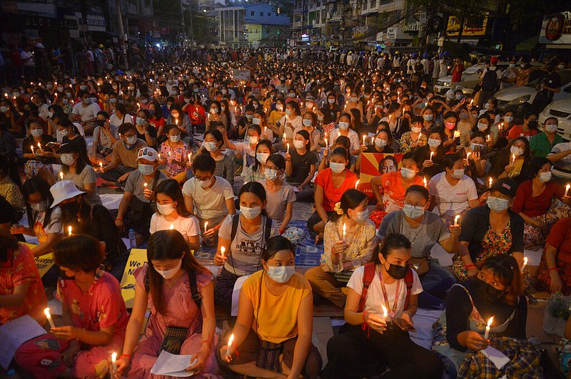 Protesters hold a candlelight rally Saturday in Rangoon, Burma, crowding a downtown commercial area despite an official 8 p.m. curfew. More photos at arkansasonline.com/314burma/.
(AP)