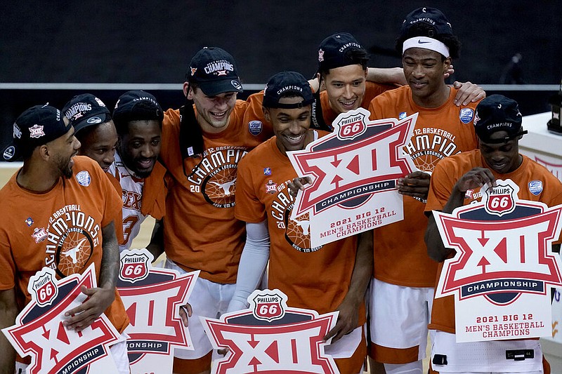 Texas players celebrate the team's win over Oklahoma State for the championship of the Big 12 men's tournament in Kansas City, Mo., on Saturday, March 13, 2021. (AP/Charlie Riedel)