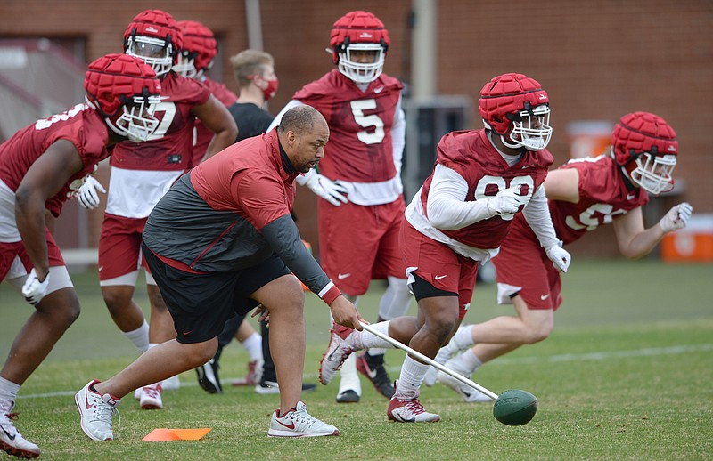 Arkansas defensive line coach Jermial Ashley (left) starts a drill Thursday, March 11, 2021, during practice at the university practice facility in Fayetteville. Visit nwaonline.com/210312Daily/ for today's photo gallery. .(NWA Democrat-Gazette/Andy Shupe)