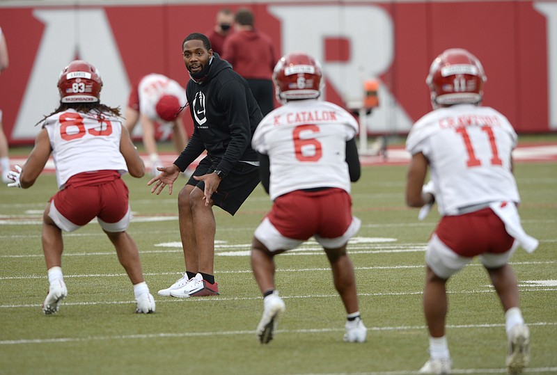 Arkansas receivers coach Kenny Guiton directs his players Tuesday, March 9, 2021, during practice at the university practice field in Fayetteville. Visit nwaonline.com/210310Daily/ for today's photo gallery. .(NWA Democrat-Gazette/Andy Shupe)