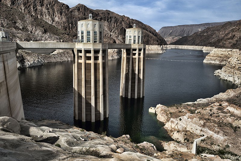 As seen from the Hoover Dam in Arizona in March 2019, a bathtub ring of light minerals shows the high water mark of the dam’s reservoir formed by the Colorado River. The river supplies Arizona, California, Colorado, Nevada, New Mexico, Utah, Wyoming and Mexico. 
(AP file photo)