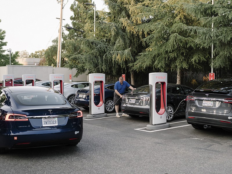 Motorists replenish their batteries at a Tesla charging station in Mountain View, Calif., in 2017. Sales of electric vehicles account for about 2% of annual new-car sales, with some forecasts projecting that number to grow rapidly.
(The New York Times/Jason Henry)
