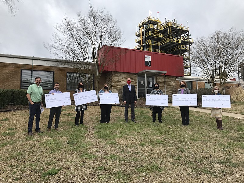 Mark Day, left, public relations and land manager for LANXESS, stands with representatives from West Side Christian School, North West Elementary, Yocum Primary, Hugh Goodwin Elemenatry, El Dorado High School and the Smackover-Norphlet School District, as well as Steffen Kahlert, site manager at LANXESS, center, as the company distributes STEM education grant awards last week. (Contributed)