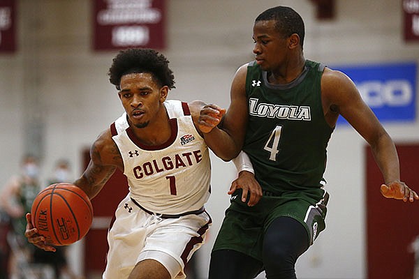 Colgate's Jordan Burns (1) drives past Loyola (Md.) Isaiah Hart ball during an NCAA college basketball game in the finals of the Patriot League tournament, Sunday, March 14, 2021, in Hamilton, N.Y. (AP Photo/John Munson)