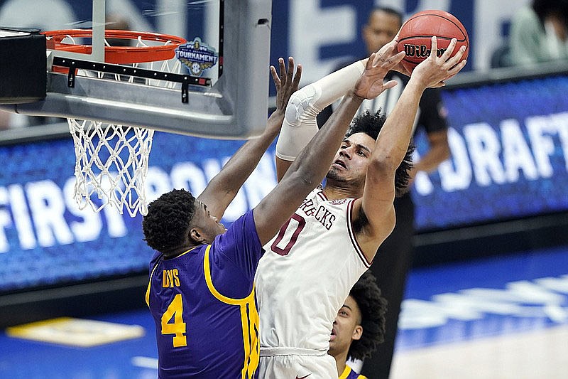 Arkansas’ Justin Smith (0) shoots against LSU’s Darius Days (4) in the second half of an NCAA college basketball game in the Southeastern Conference Tournament Saturday in Nashville, Tenn.