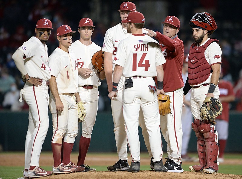Arkansas coach Dave Van Horn signals to the bull pen for the RazorbacksÕ 10th pitcher of the game to enter the field Tuesday, March 16, 2021, during the ninth inning of the RazorbacksÕ 8-5 loss to Oklahoma at Baum-Walker Stadium in Fayetteville. Visit nwaonline.com/210317Daily/ for today's photo gallery. .(NWA Democrat-Gazette/Andy Shupe)