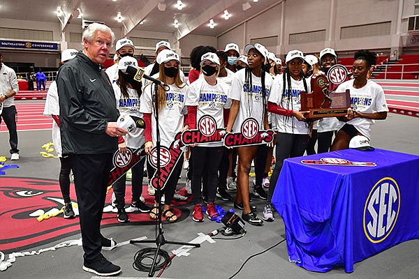 Arkansas coach Lance Harter (left) speaks after the Razorbacks won the SEC Indoor Track and Field Championships team title on Saturday, Feb. 27, 2021, in Fayetteville.