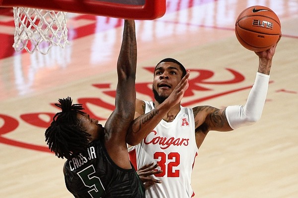 Houston forward Reggie Chaney (32) shoots as Tulane forward Kevin Cross defends during the second half of an NCAA college basketball game, Saturday, Jan. 9, 2021, in Houston. (AP Photo/Eric Christian Smith)