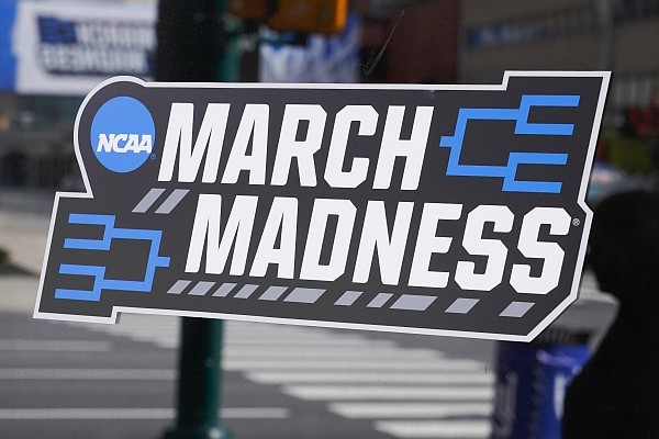 A March Madness sticker for the NCAA college basketball tournament is placed on a window in downtown Indianapolis, Wednesday, March 17, 2021. (AP Photo/Darron Cummings)