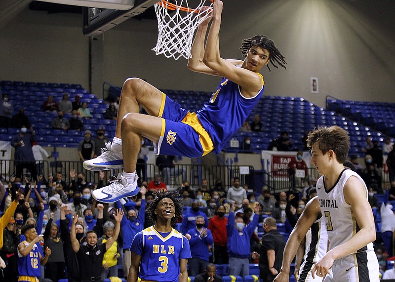 North Little Rock’s Kel’el Ware hangs on the rim after a dunk during the fourth quarter of the Charging Wildcats’ 65-55 victory over Little Rock Central in the Class 6A championship Thursday at Bank OZK Arena in Hot Springs. More photos available at arkansasonline.com/319boys6a.
(Arkansas Democrat-Gazette/Thomas Metthe) North Little Rock’s Kel’el Ware hangs on the rim after a dunk during the fourth quarter of the Charging Wildcats’ 65-55 victory over Little Rock Central in the Class 6A championship Thursday at Bank OZK Arena in Hot Springs. More photos available at arkansasonline.com/319boys6a.
(Arkansas Democrat-Gazette/Thomas Metthe)